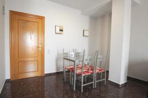 a room with a table and chairs and a door at HOTEL MARIA ROSA in Pedrola