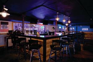 a bar with a bunch of bar stools at Getaway At The Marina in Sarasota