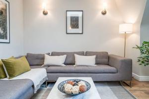a living room with a couch and a table at Be London - Marylebone Residences in London