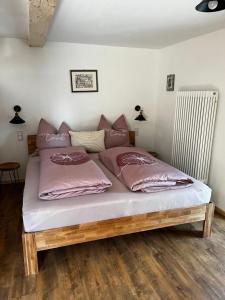 a bed with two pillows on it in a room at Scheune 65 in Bad Frankenhausen