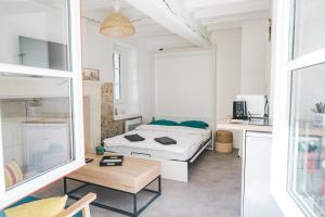 a bedroom with a bed and a table in a room at Nouveau - AuPetitSaumur in Saumur