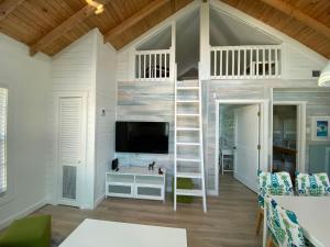 a treehouse room with a tv and a loft bed at Maria's Los Cirhuelos in Homestead
