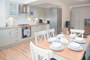 uma cozinha e sala de jantar com mesa e cadeiras em Knollmead House em Surbiton