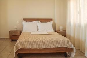 a bedroom with a large bed with two night stands at Apartment by the sea in Stalida