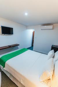 Postel nebo postele na pokoji v ubytování Hotel Hacienda Lima Norte