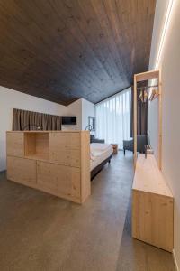 Agriturismo B&B Caffè e Vino في سوندريو: غرفة نوم بسرير وسقف خشبي