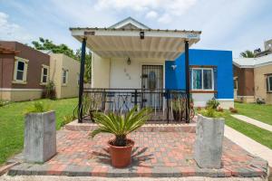 a house with a gate and a potted plant at Nickels Garden Villas in Montego Bay
