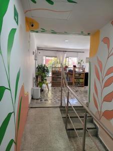 a hallway with a staircase with a mural on the wall at MonDieu Hostel in Barranquilla