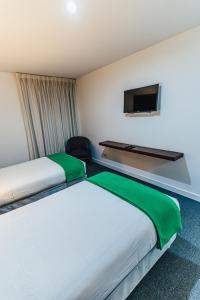Postel nebo postele na pokoji v ubytování Hotel Hacienda Lima Norte