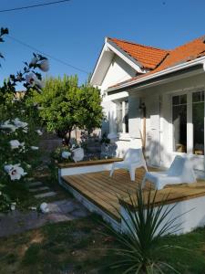 a wooden deck in front of a house at La Petite Etoile in Andernos-les-Bains