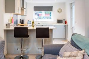 a kitchen and living room with a couch and a counter at Ideal Couples base for exploring the Island in Shiskine