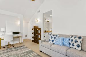 a living room with a couch and a desk at Koolkondo Luxury Designer Condo in Koloa
