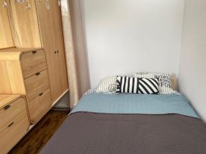 a small bedroom with a bed and a dresser at EcoRelax in Błotnik