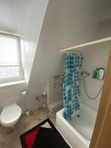 a small bathroom with a toilet and a shower at Hostel Nuremberg in Nuremberg +42 photos