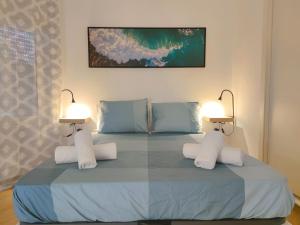 a bedroom with a bed with two lamps on it at Las Tortugas 350mt from the beach wi-fi free in Playa de las Americas