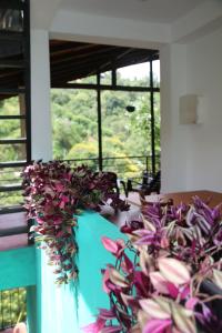 a bunch of flowers on a table in a room at Rawana Mountain View Homestay in Ella
