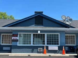 a house with two orange cones in front of it at Washington & Lee Motel in East End