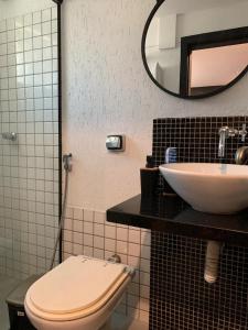 a bathroom with a toilet and a sink at Studio aconchegante em Barra Mansa in Barra Mansa