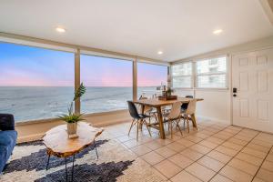 uma sala de jantar com uma mesa e vista para o oceano em Seafoam Sunset em San Diego