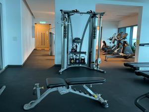 a gym with several tread machines and people exercising at Eaton Suites KLCC in Kuala Lumpur