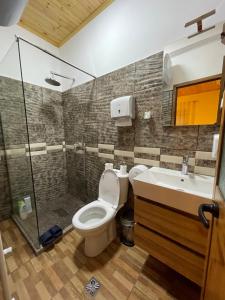 a bathroom with a toilet and a sink and a shower at Bar Restaurant Hotel ''Te Gusti'' in Tamarë