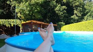 a person with their feet up in a swimming pool at Ferienwohnung Herold in Wessobrunn