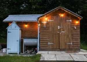 a wooden out house with a dog in it at Cosy Pod-Cabin near beautiful landscape in Omagh in Omagh
