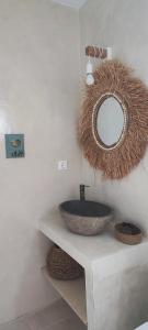 a bathroom with a sink and a mirror on the wall at Diana's Luxury Suites in Kithnos