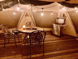 a room with a table and chairs in a tent at North Villge Hirugano - Vacation STAY 32983v in Gujo