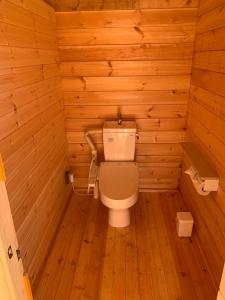 a bathroom with a toilet in a wooden room at North Villge Hirugano - Vacation STAY 32983v in Gujo