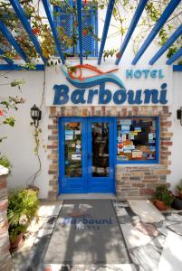 a restaurant with a blue door at Barbouni Hotel & Studios in Naxos Chora