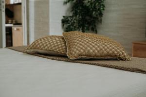 two pillows sitting on top of a bed at AMÀRE Relais Home in Bari