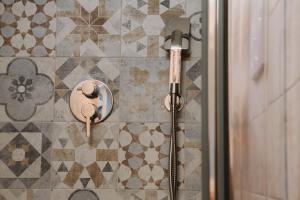 a shower in a bathroom with a glass door at AMÀRE Relais Home in Bari +19 photos