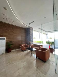 a lobby with couches and a table in a building at Sewa Apartemen Jogja MATARAM CITY in Kejayan