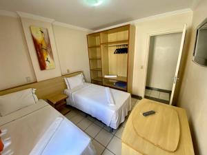 Habitación de hotel con 2 camas y TV en Hotel Villas diRoma com um dia de acesso no diRoma Acqua Park,, en Caldas Novas
