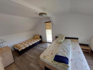 a bedroom with a bed and a couch in it at CABANA CASA LU'BACIU in Arpaşu de Sus +55 photos