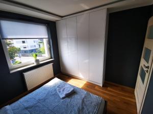 a bedroom with a bed and a window at Apartament SIECHNICE in Siechnice