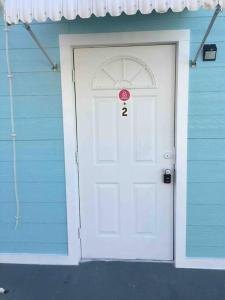 a blue house with a white door with a number on it at Sunshine in Tampa