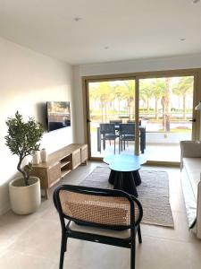 a living room with a table and a couch at Acacias Suites Apartments Salou in Salou
