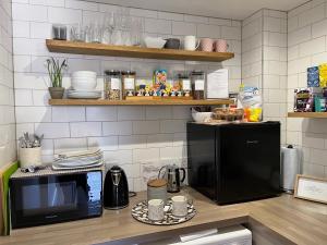 a kitchen with a counter top with a microwave and a counter sidx sidx at No 12 Furze Croft in St Ives