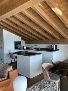 a kitchen with white cabinets and a counter top at LE 1307 in Megève