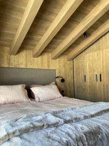a bedroom with a large bed with a wooden ceiling at LE 1307 in Megève