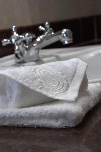 a white towel sitting on top of a bathroom sink at Kampala Serena Hotel in Kampala
