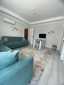 a living room with a green couch and a table at CeylanHouse-3 in Dalaman