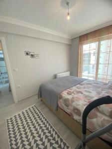 een slaapkamer met een bed en een groot raam bij CeylanHouse-3 in Dalaman