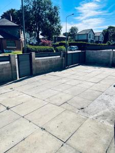 a large concrete parking lot with a fence and houses at UNIQUE ROOMS! 4beds double bed in Farnworth