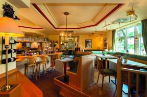 a restaurant with tables and chairs and a bar at Akzent Hotel-Restaurant Albert in Dorsten