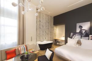 a hotel room with a large bed and a large window at Le Cinq Codet in Paris