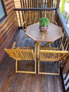 a wooden table and chairs on a wooden deck at Luxury Wooden Villas in Makrygialos