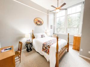 a bedroom with a bed and a window at Northside School Bed & Breakfast in Bonners Ferry